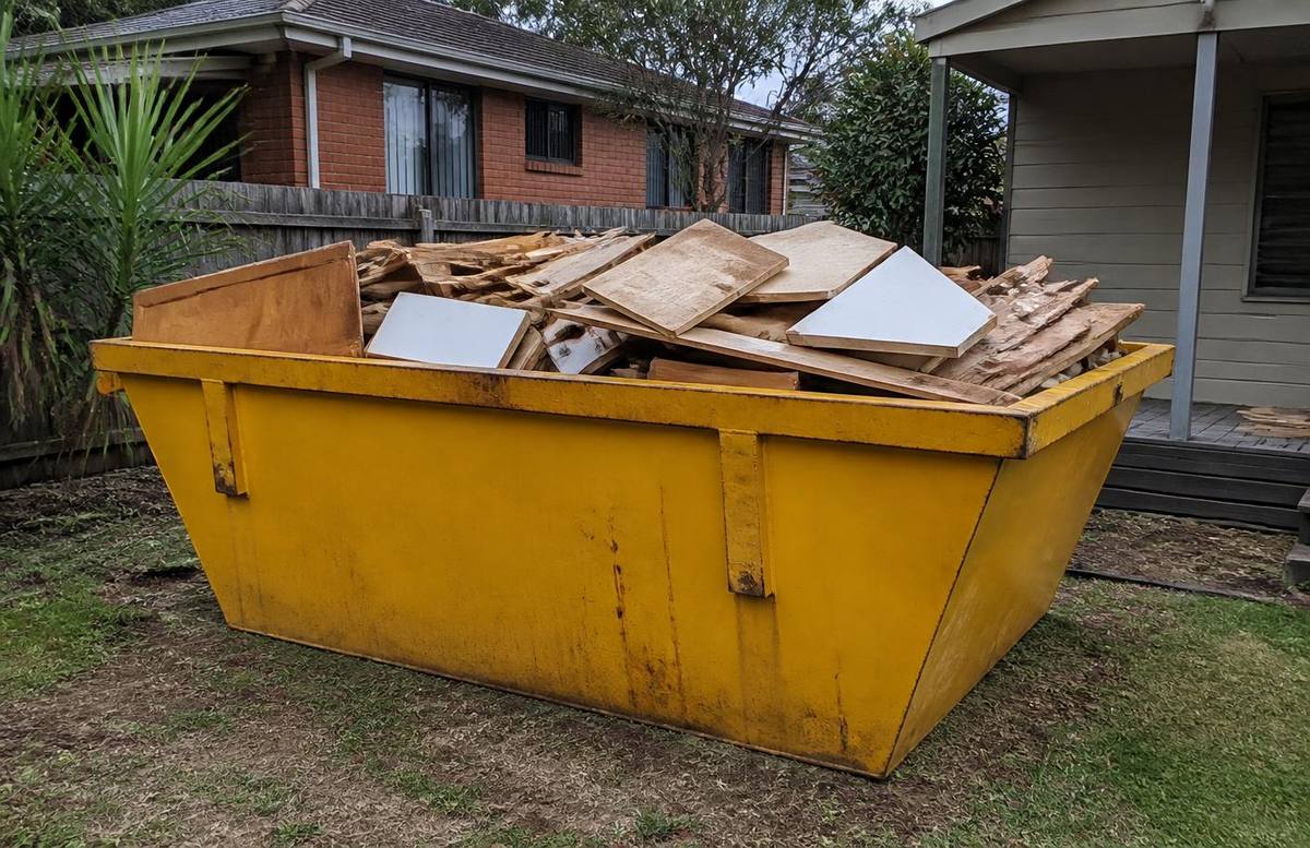 Skip bin loaded with timber, cabinetry and plasterboard from a home renovation strip-out